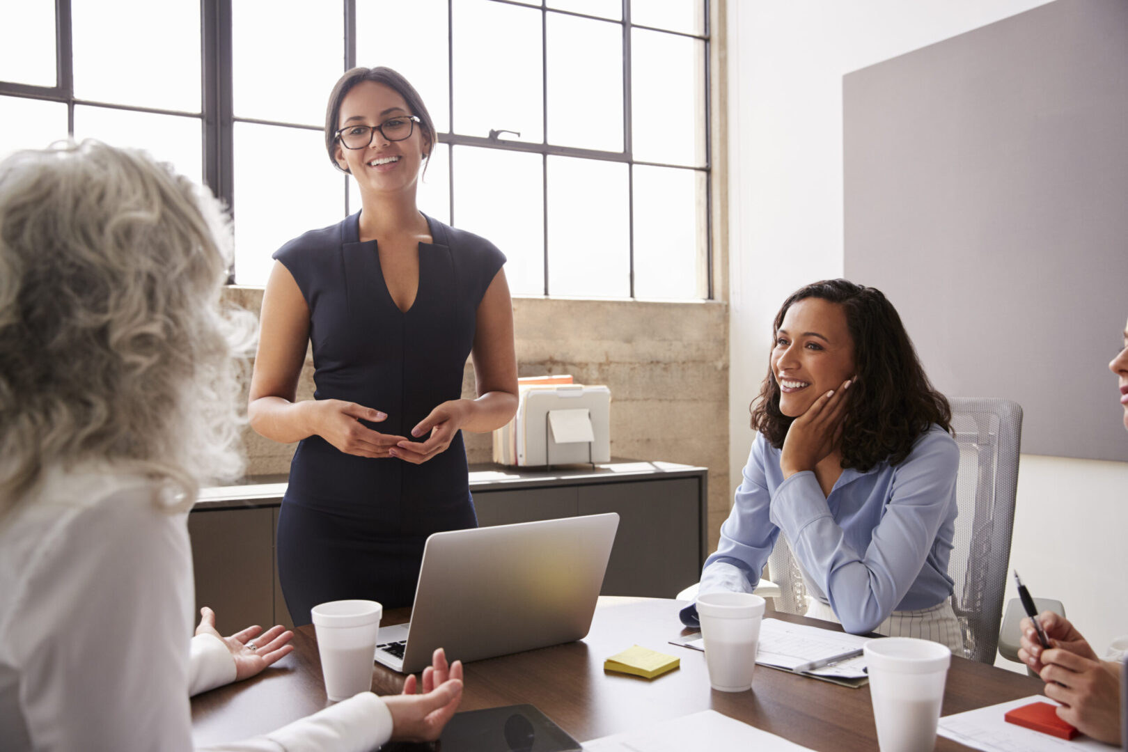 Woman presenting to colleagues during a meeting